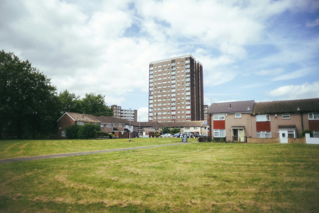 Urban residential area with tower block in Leeds, sunny day.